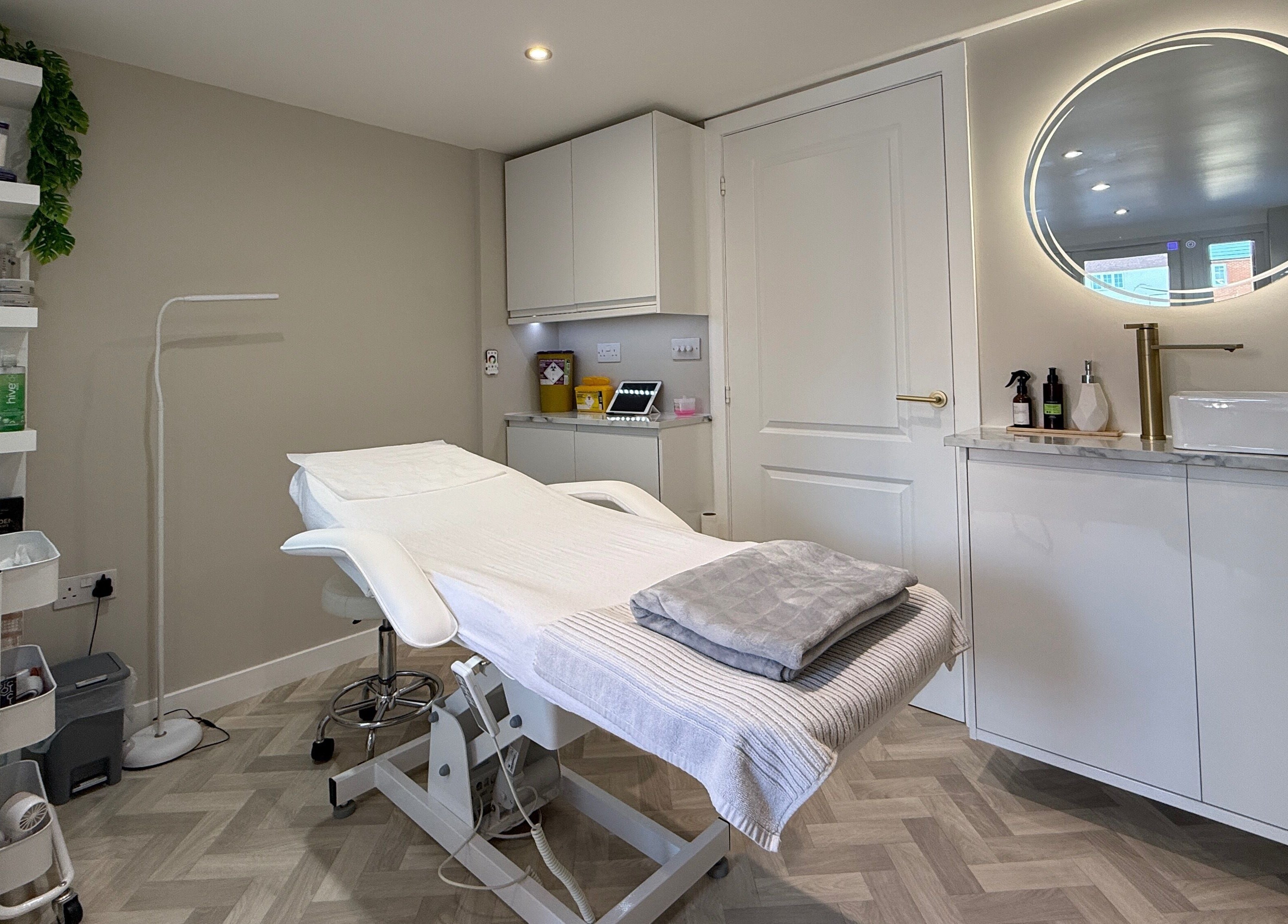 Chic treatment room at Plush Beauty Box, Exeter, England, GB with modern decor and comfortable bed.