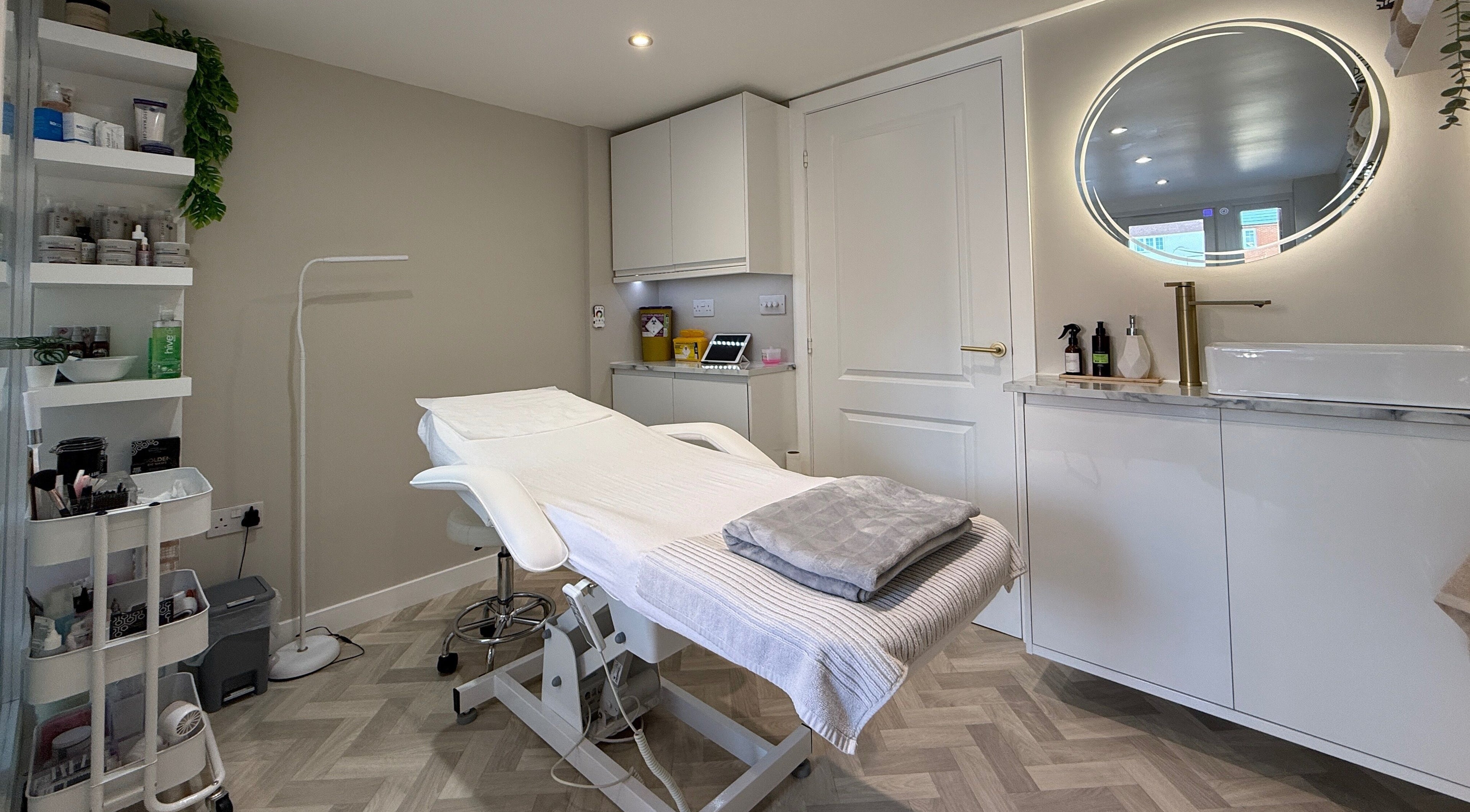 Chic treatment room at Plush Beauty Box, Exeter, England, GB with modern decor and comfortable bed.