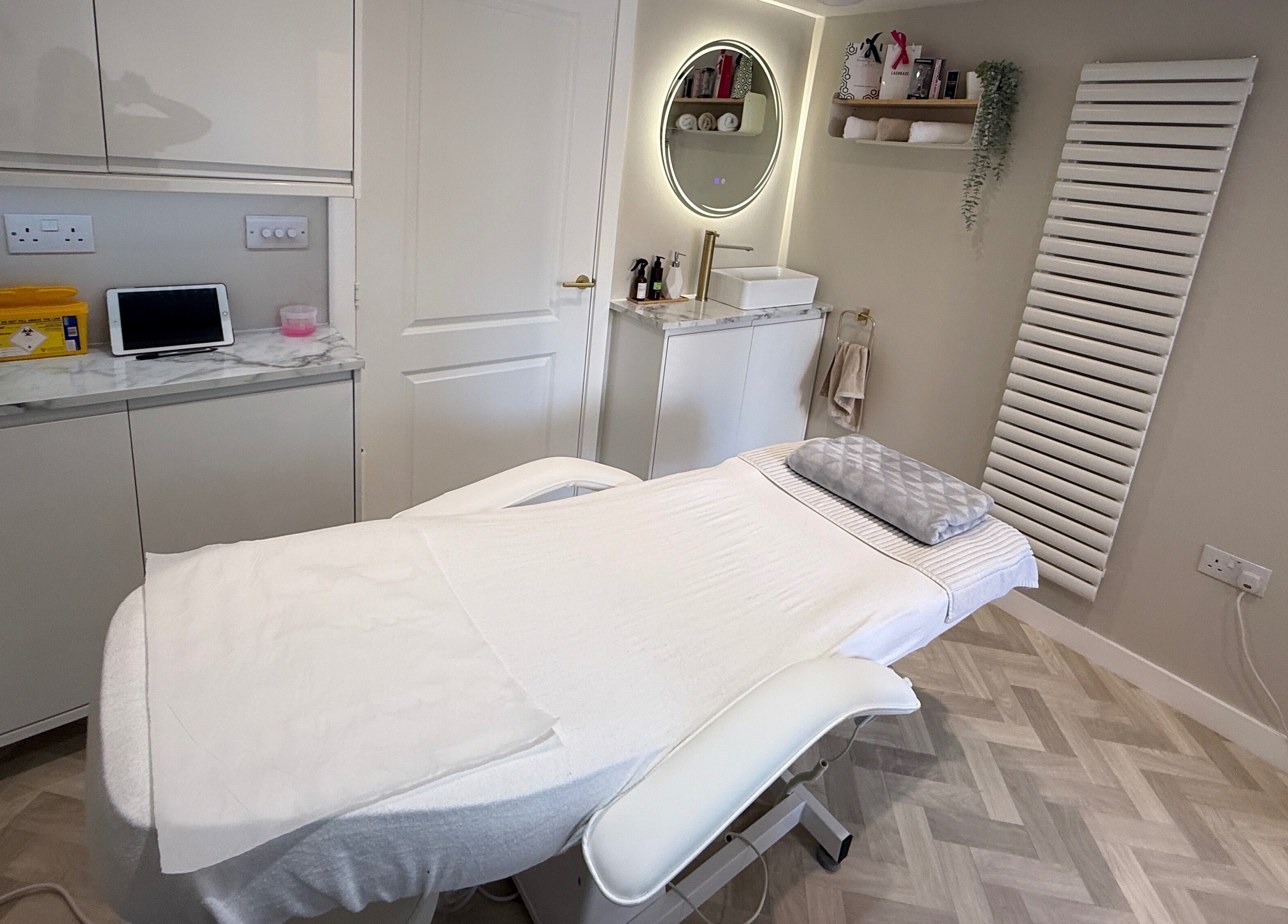 Treatment room at Plush Beauty Box in Exeter, England, GB with modern decor and a comfortable bed.