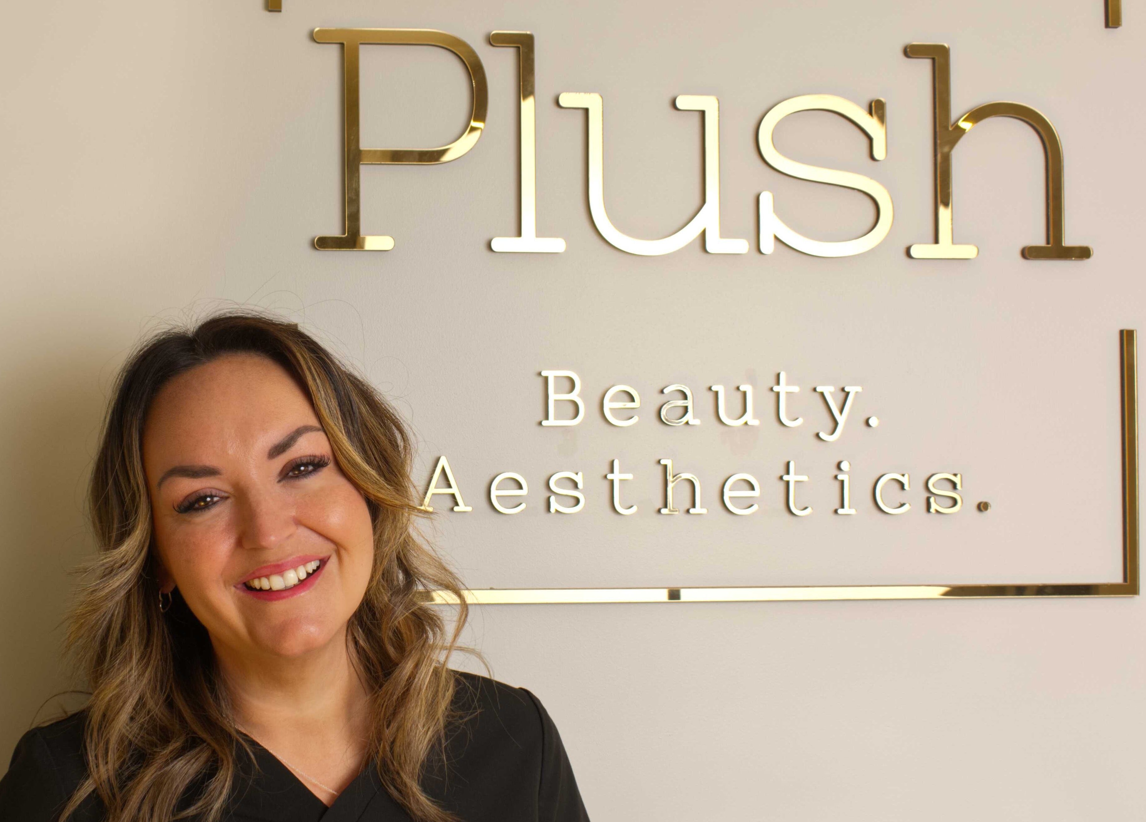 Smiling staff at Plush Beauty Box in Exeter, England, GB, with sign reading 'Beauty Aesthetics'.