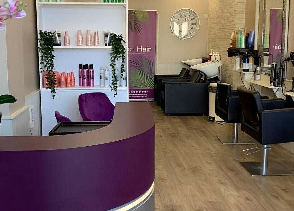Interior of Mac Hair salon, Southampton, England with modern decor, styling chairs and vibrant product displays.