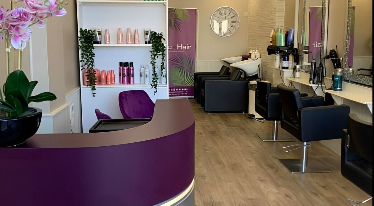 Interior of Mac Hair salon, Southampton, England with modern decor, styling chairs and vibrant product displays.