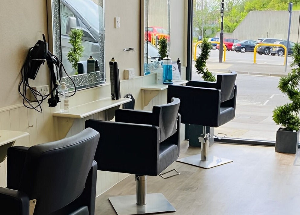 Modern salon chairs and mirrors at Mac Hair in Southampton, England, GB with street view ambiance.
