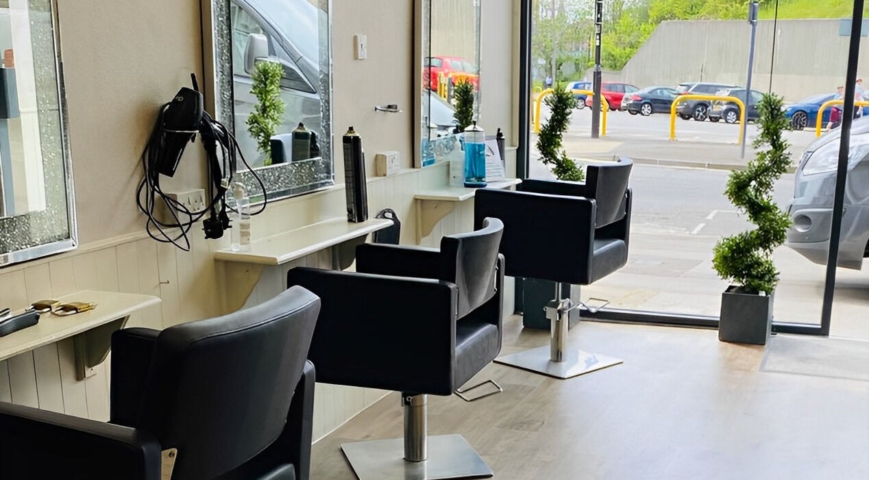 Modern salon chairs and mirrors at Mac Hair in Southampton, England, GB with street view ambiance.