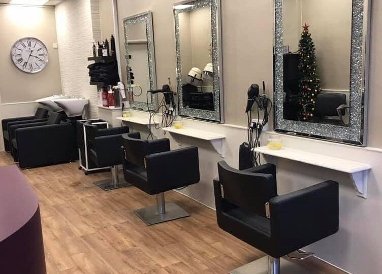 Modern salon interior at Mac Hair in Southampton, England, GB with chic styling stations and chairs.