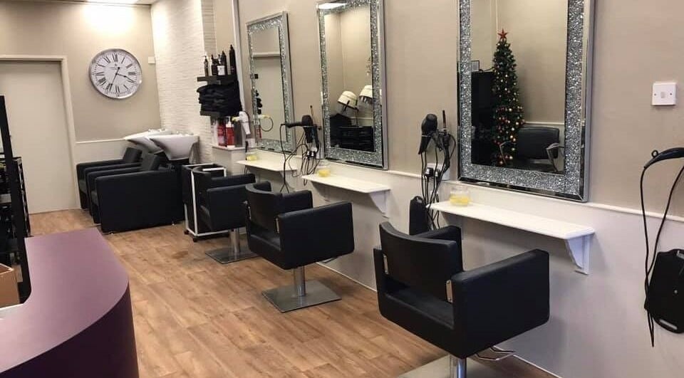 Modern salon interior at Mac Hair in Southampton, England, GB with chic styling stations and chairs.