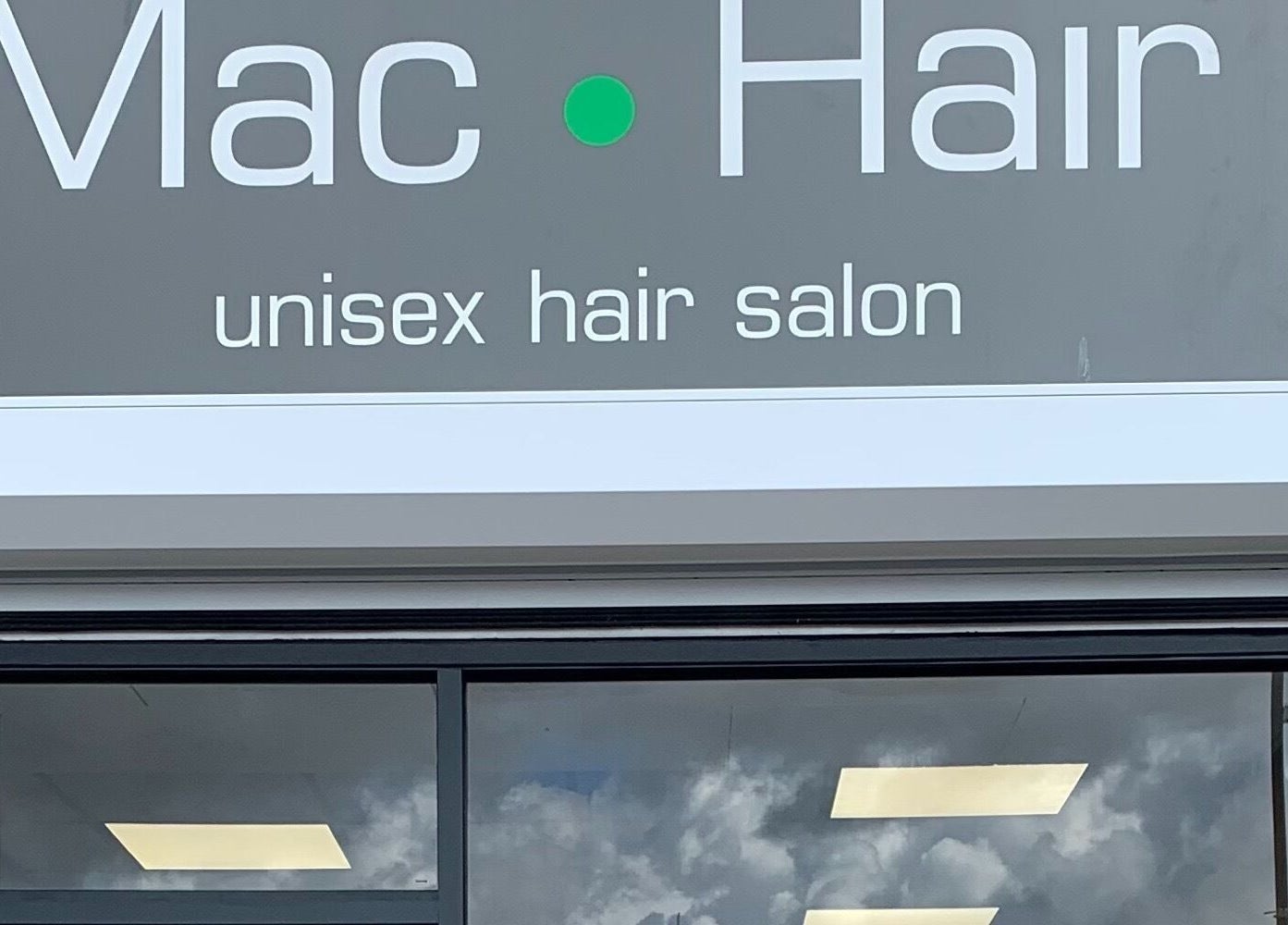 Signage of Mac Hair unisex hair salon in Southampton, England, GB, displaying modern aesthetics.