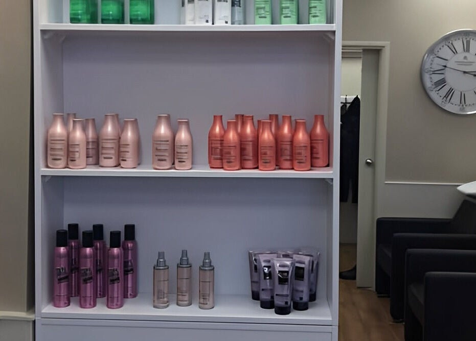 Product shelves at Mac Hair in Southampton, England, GB displaying a range of hair care products and a chic interior.