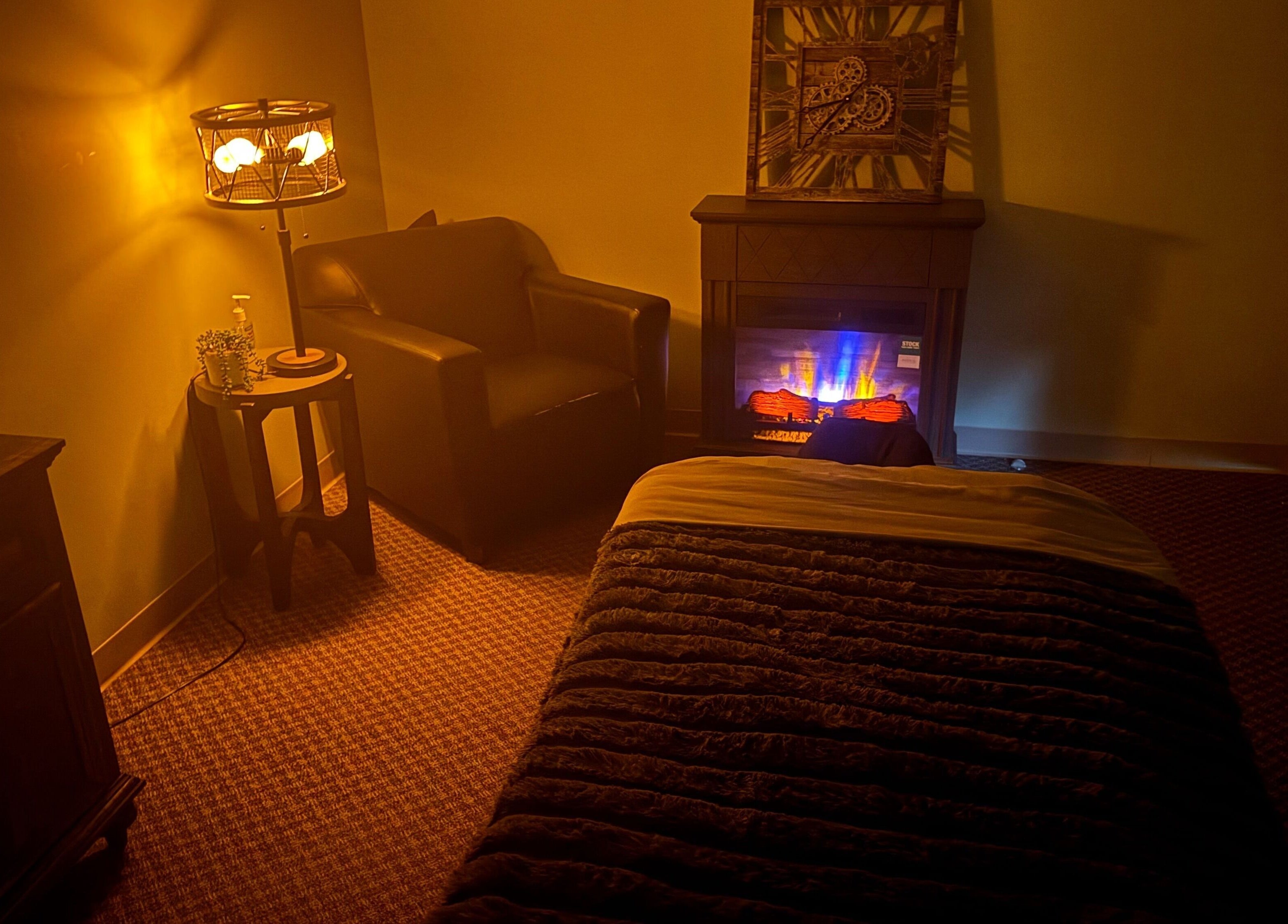 Comfortable massage room with warm lighting at Manna Medical Massage, Burton, Michigan, US.