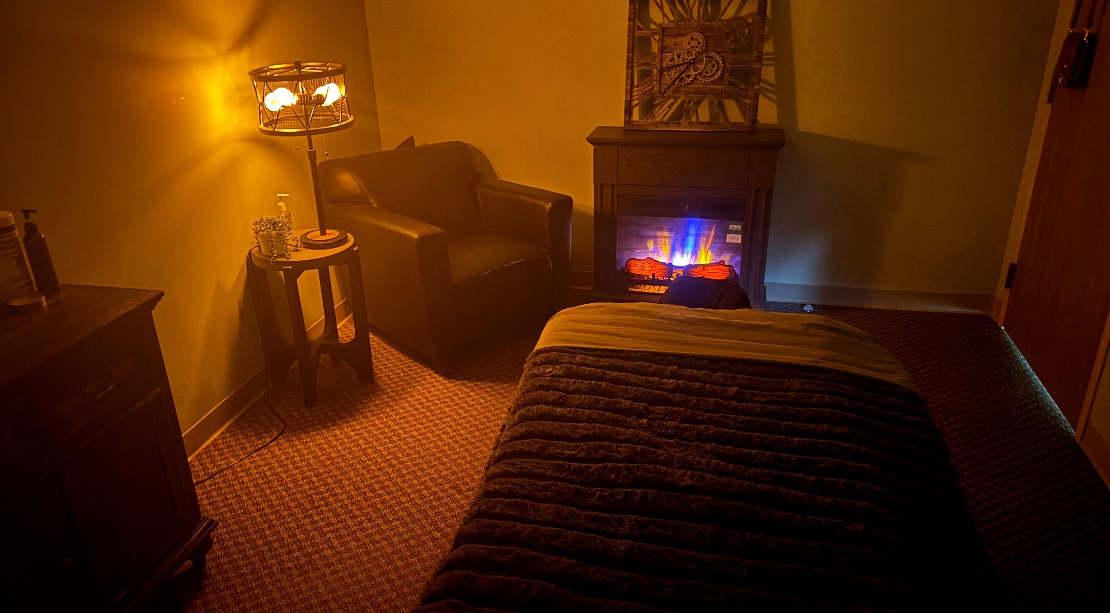 Comfortable massage room with warm lighting at Manna Medical Massage, Burton, Michigan, US.