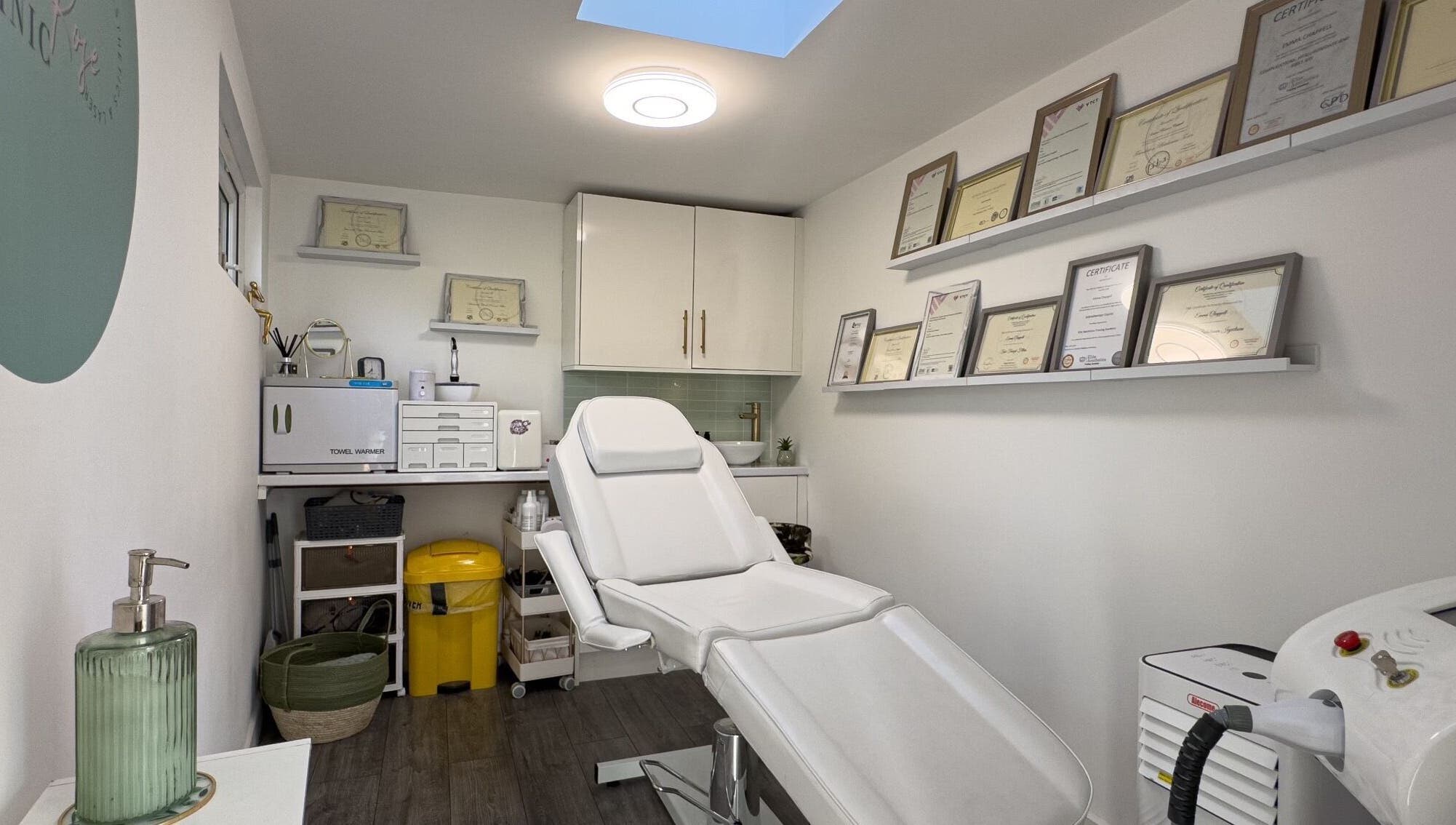 Interior view of Emma Rose Aesthetics & Laser Clinic, Bristol, England, GB, showing a treatment room with certificates.