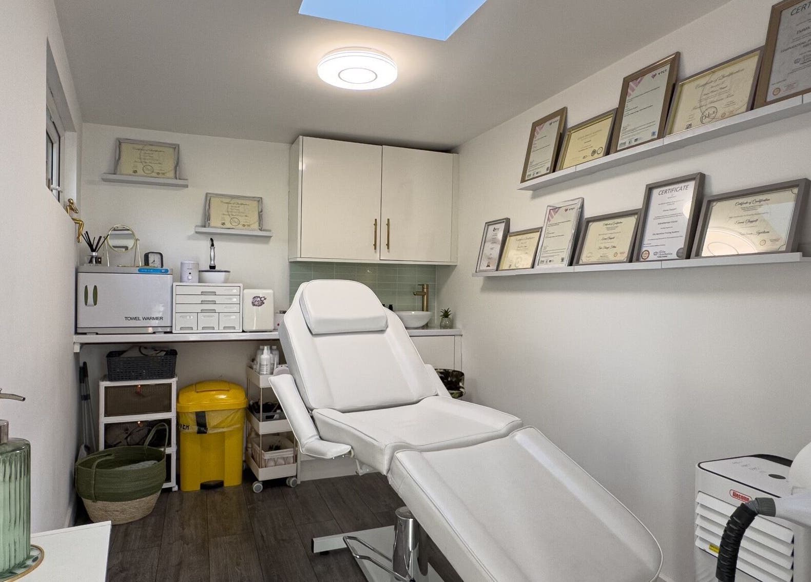 Interior view of Emma Rose Aesthetics & Laser Clinic, Bristol, England, GB, showing a treatment room with certificates.