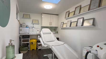 Interior view of Emma Rose Aesthetics & Laser Clinic, Bristol, England, GB, showing a treatment room with certificates.