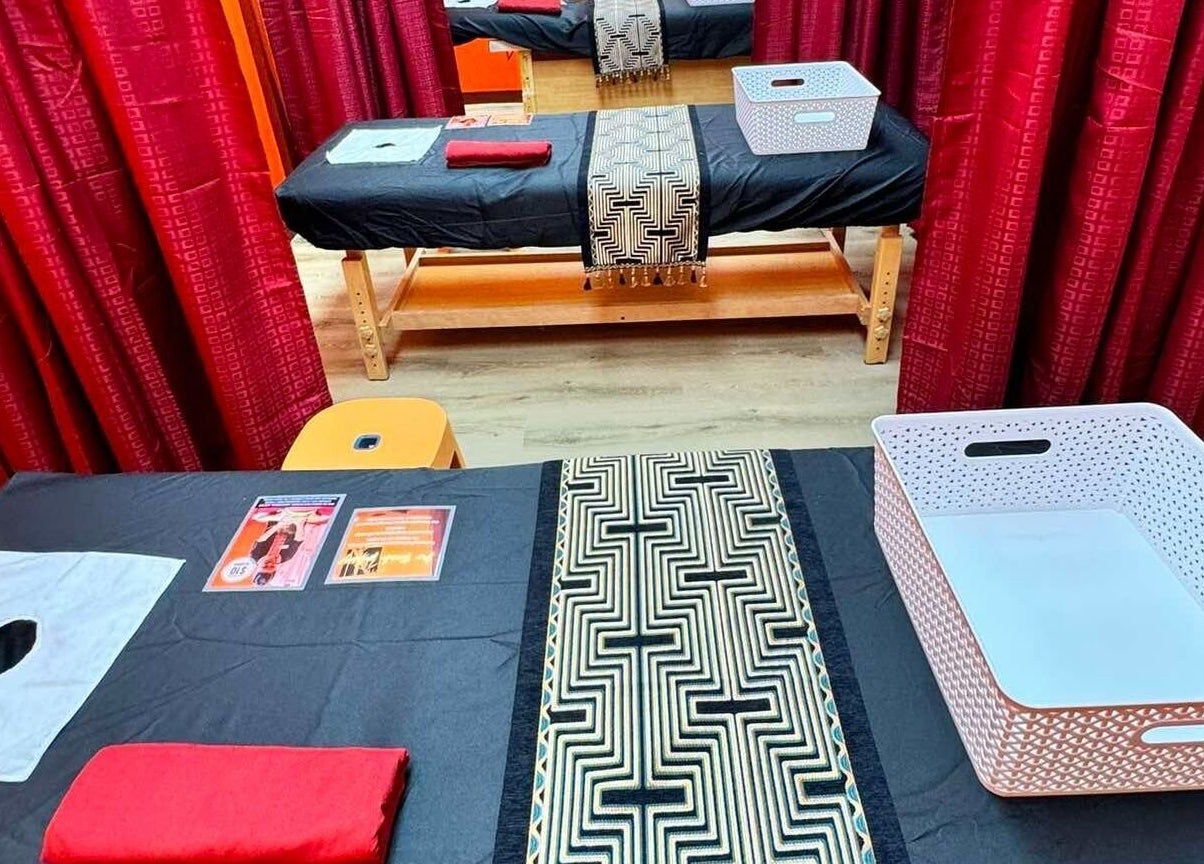 Relaxing massage tables at Bamboo Spa Papakura in Auckland, Auckland, NZ, featuring elegant red curtains.
