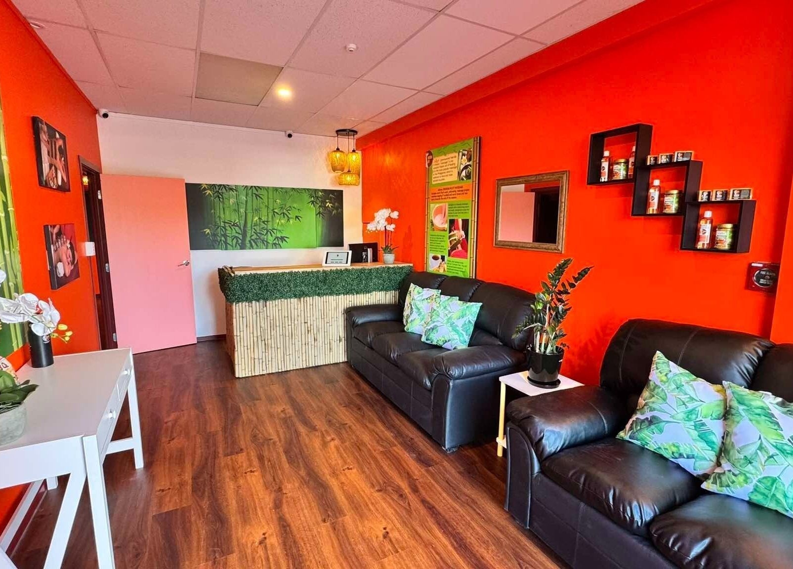 Vibrant reception area at Bamboo Spa Botany, Auckland, NZ. Features cozy seating and lush decor.