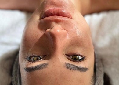 Facial treatment at Siberica Body&Mind Studio, Gosford, New South Wales, AU. Close-up of serene face on white towel.