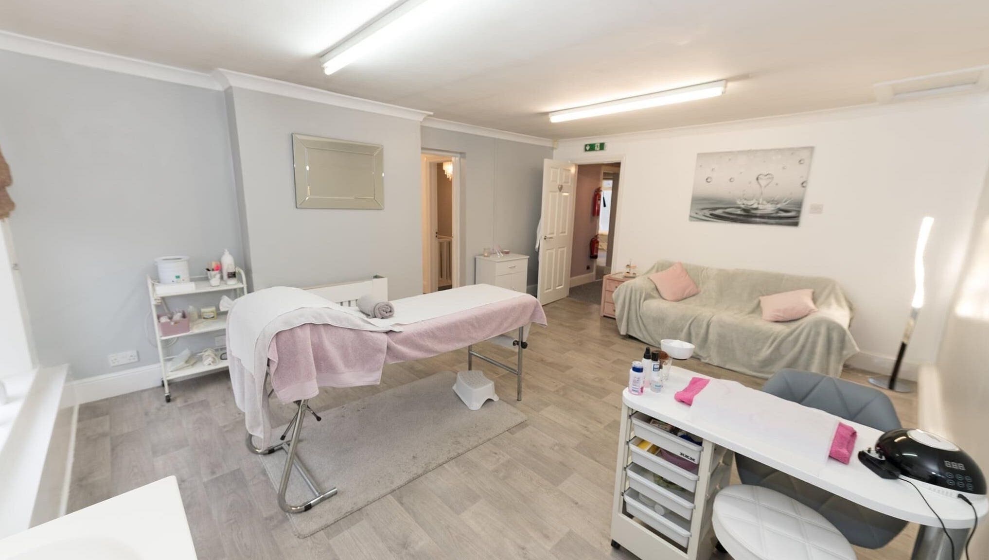 Relaxing treatment room at Beauty Within, Bristol, England, GB, with soft lighting, massage table, and calming decor.