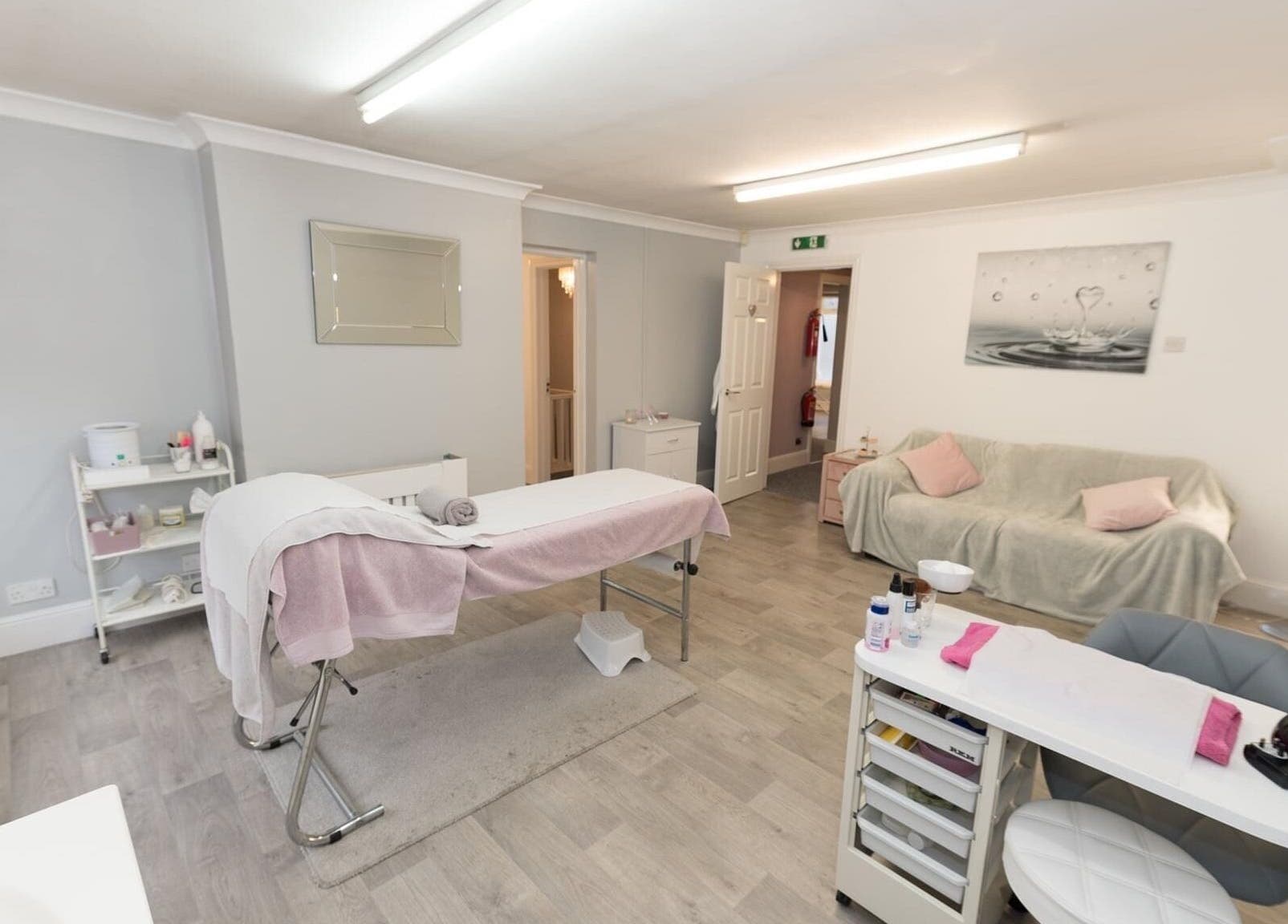 Relaxing treatment room at Beauty Within, Bristol, England, GB, with soft lighting, massage table, and calming decor.
