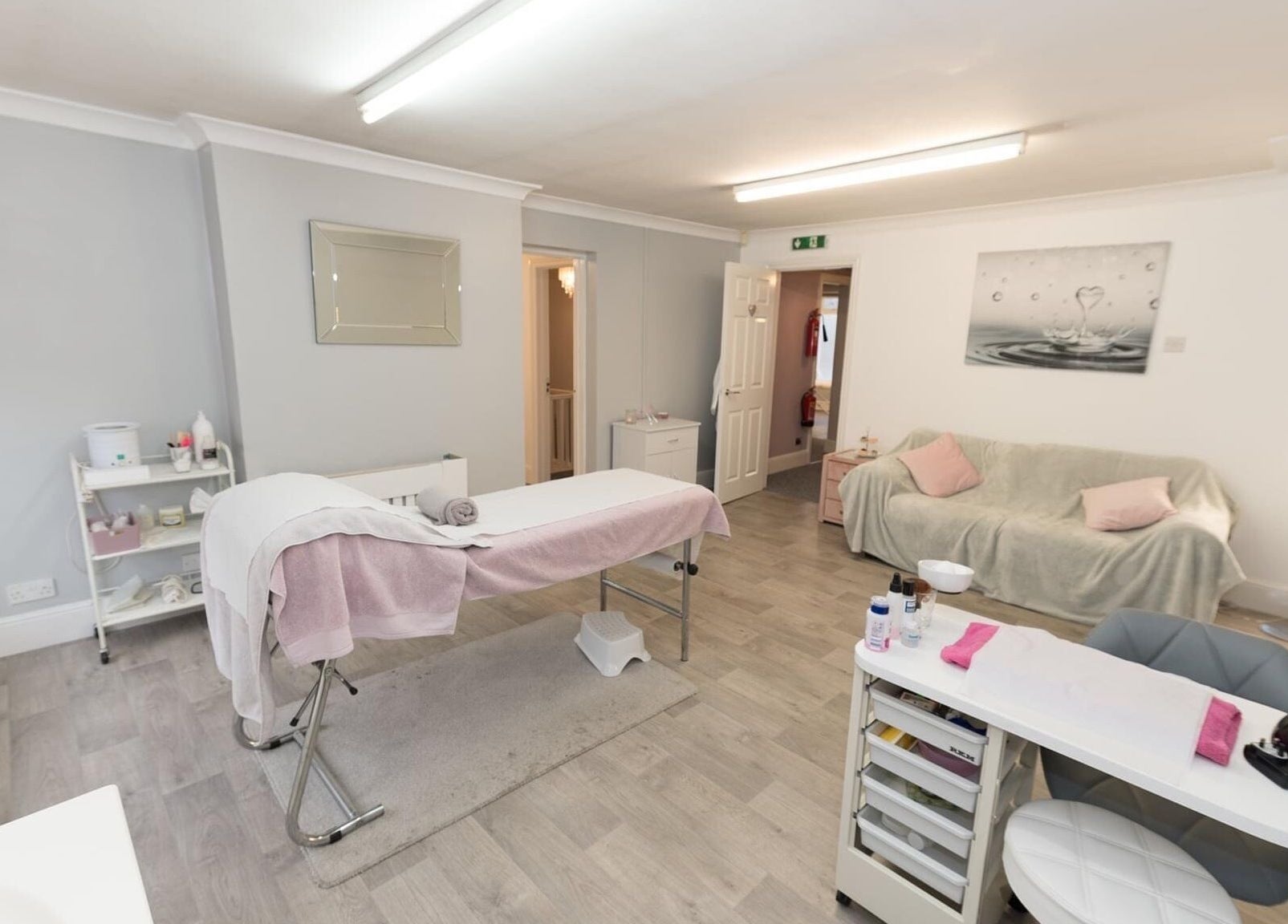 Relaxing treatment room at Beauty Within, Bristol, England, GB, with soft lighting, massage table, and calming decor.