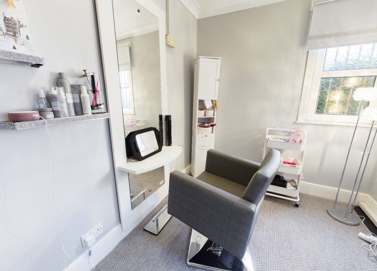 Stylish salon corner at Beauty Within, Bristol, England, GB, showcasing elegant decor and modern styling chair.