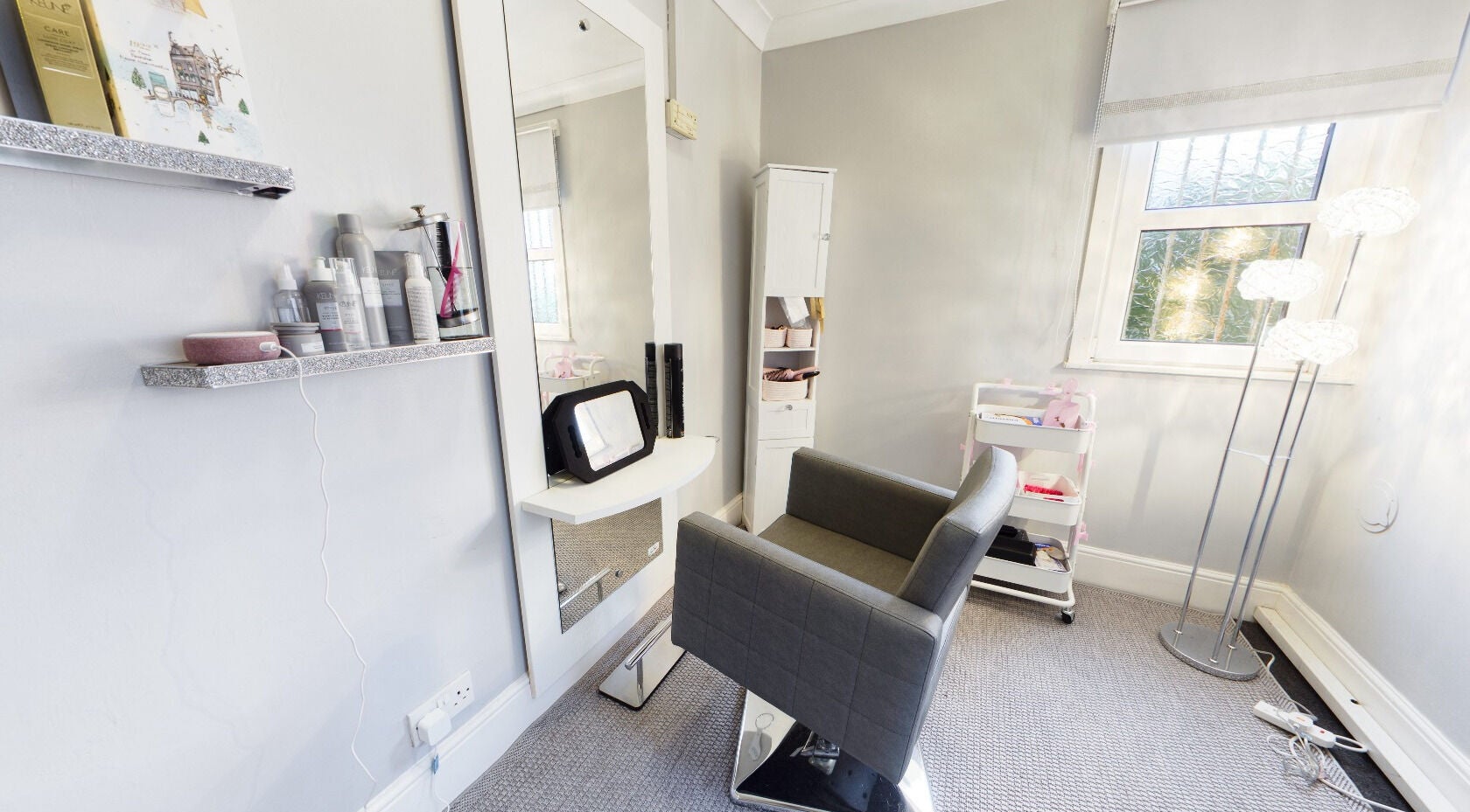 Stylish salon corner at Beauty Within, Bristol, England, GB, showcasing elegant decor and modern styling chair.