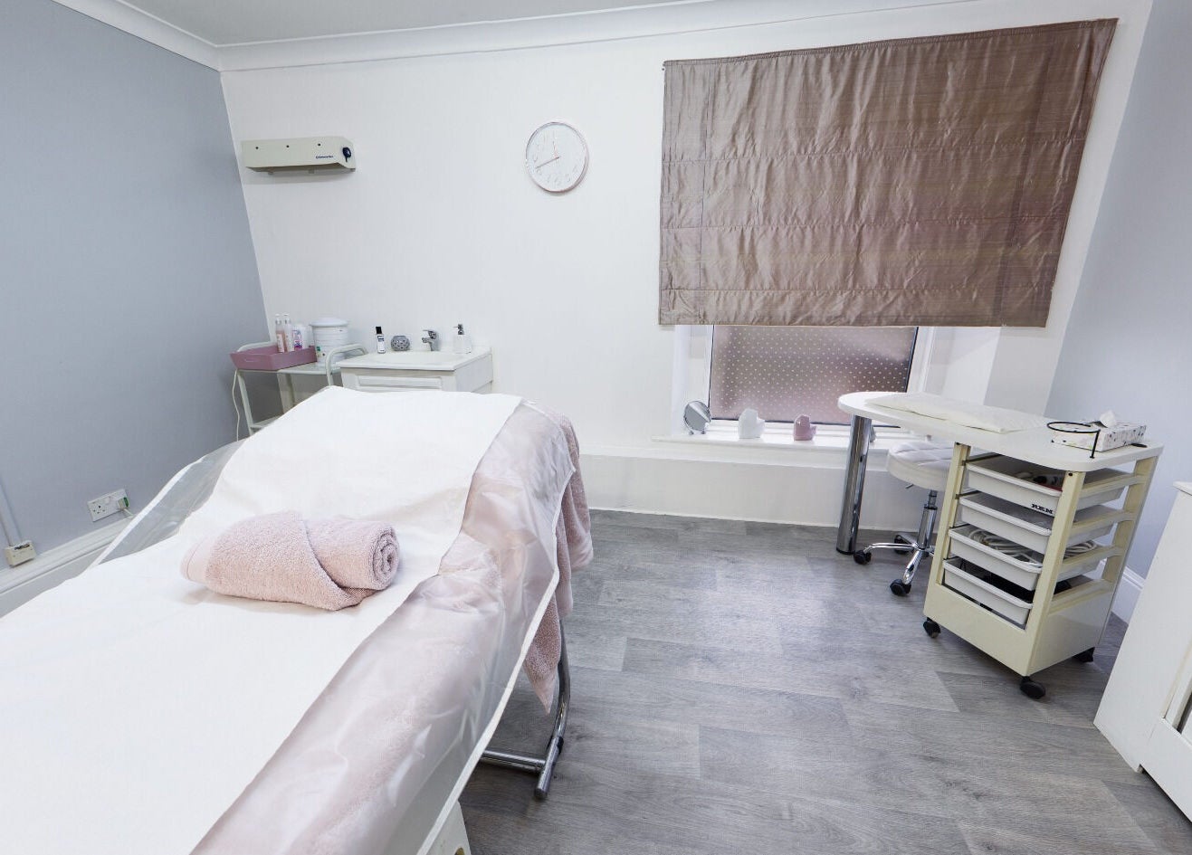 Serene spa room at Beauty Within, Bristol, England, GB, featuring a massage table and modern decor.