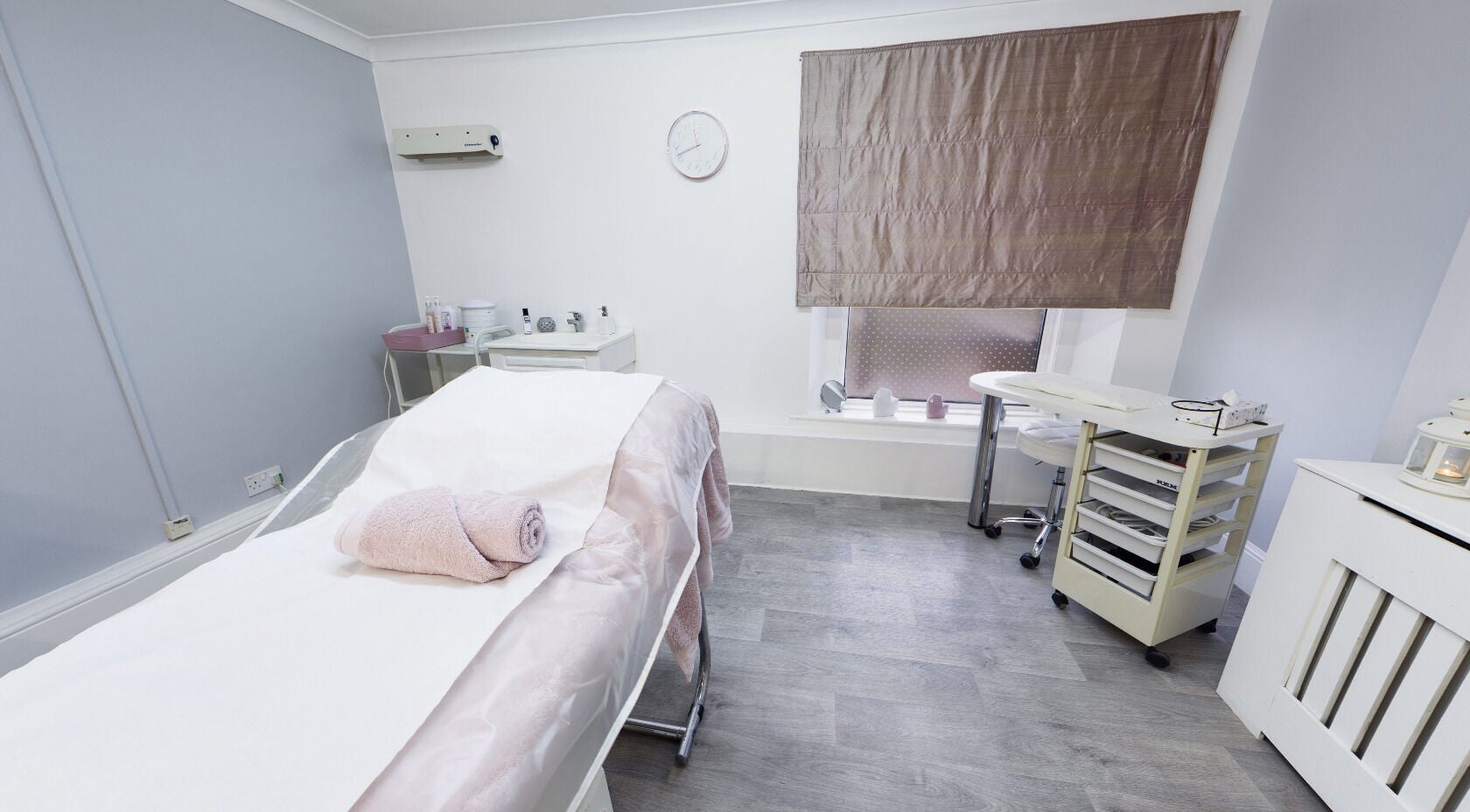 Serene spa room at Beauty Within, Bristol, England, GB, featuring a massage table and modern decor.