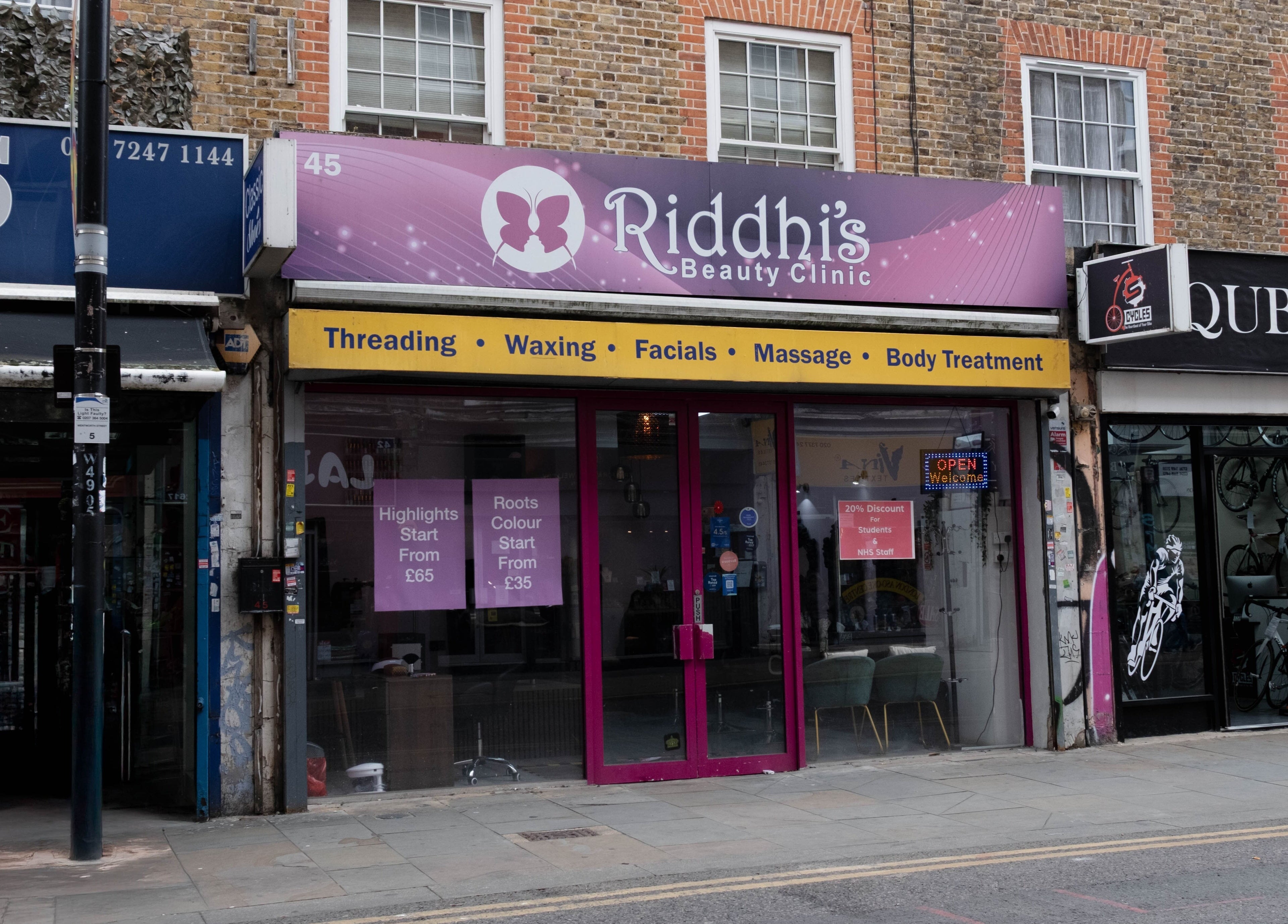 Riddhis Beauty Clinic storefront in London, England, GB, offering threading, waxing, facials, and more.