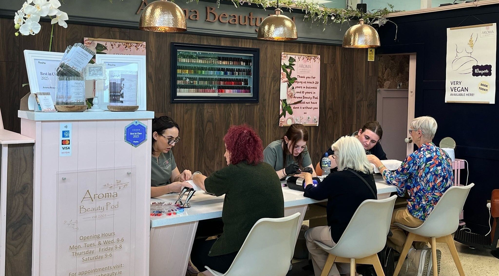 Clients enjoying nail care at Aroma Beauty Pod in Wexford, County Wexford, IE with experts providing service.