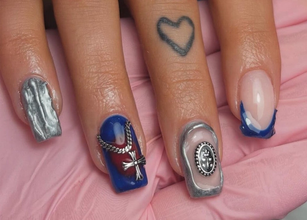 Intricate nail art at Nails By Teyah B in Manchester, England, GB showcasing elegant metallic designs.