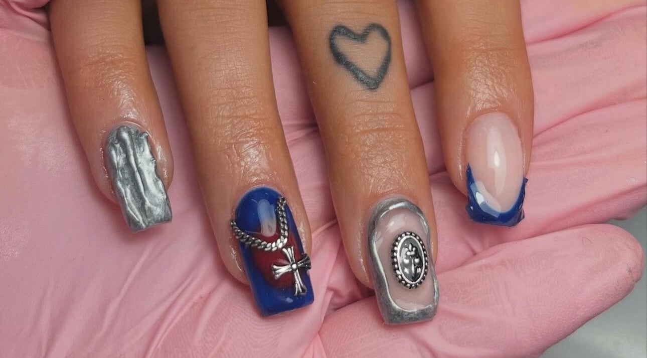 Intricate nail art at Nails By Teyah B in Manchester, England, GB showcasing elegant metallic designs.