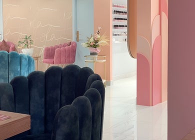 Elegant interior of Hola Spa and Cafe, Al Batinah South Governorate, OM with pastel decor and plush seating.