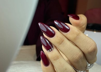 Elegant burgundy nails with gloss finish at Hola Spa and Cafe, Al Batinah South Governorate, OM.