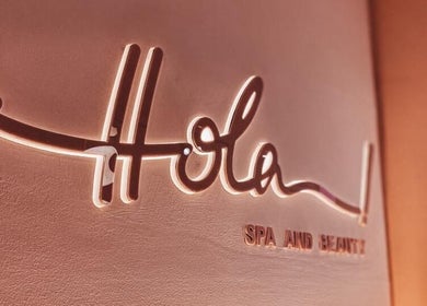 Elegant illuminated sign at Hola Spa and Cafe, Al Batinah South Governorate, OM.