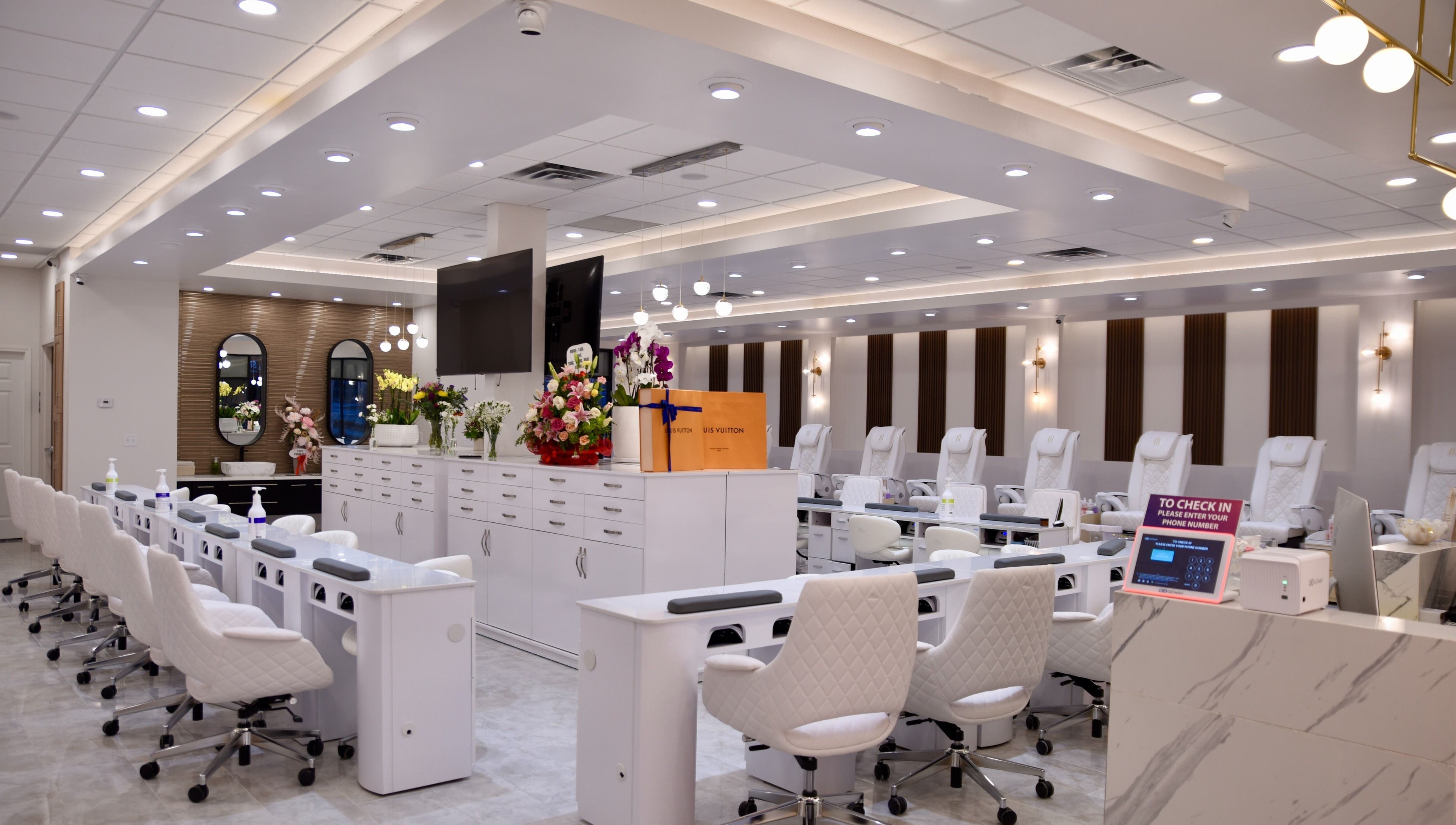 Interior of NT Nail Lab in Sauk Rapids, Minnesota, US, featuring sleek white nail stations and modern decor.