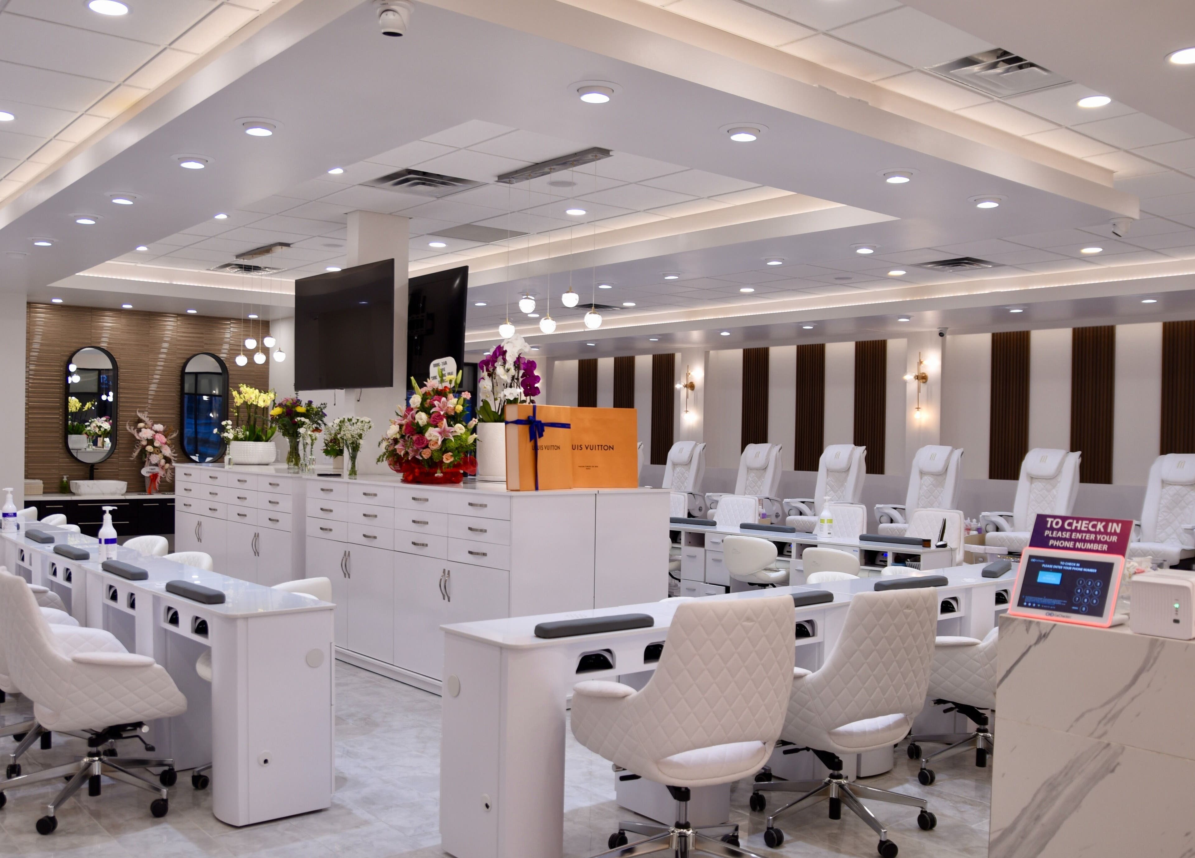 Interior of NT Nail Lab in Sauk Rapids, Minnesota, US, featuring sleek white nail stations and modern decor.