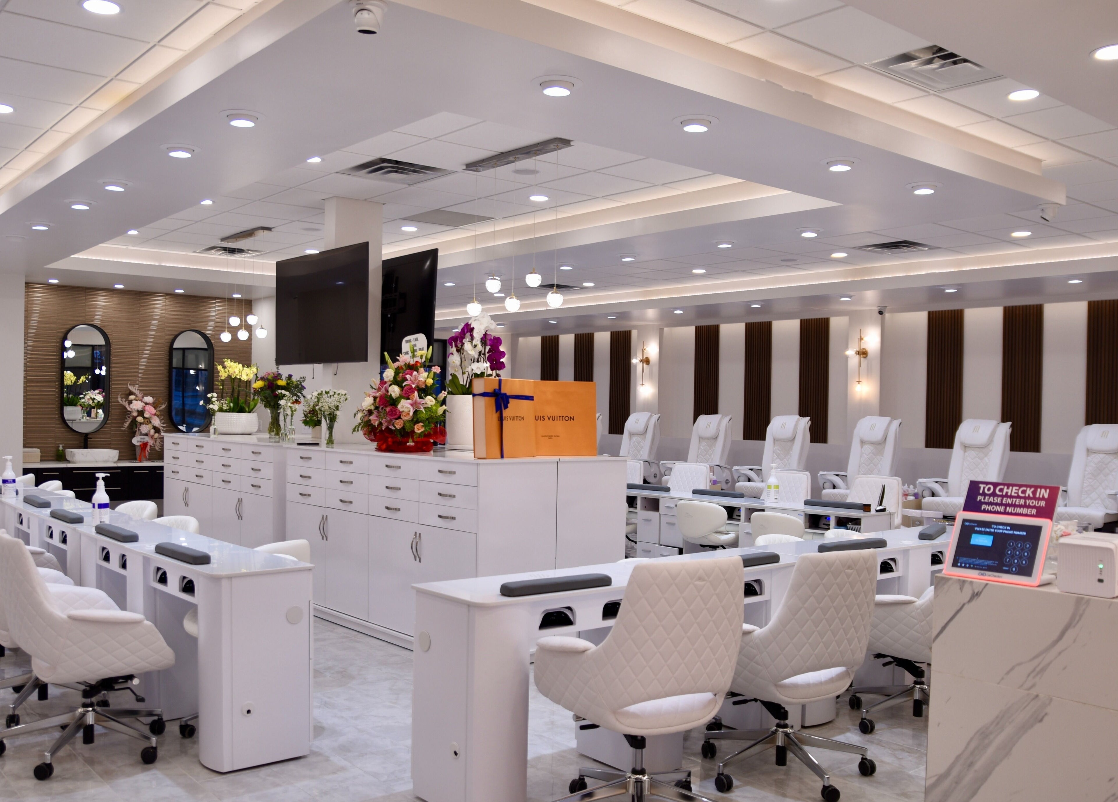 Interior of NT Nail Lab in Sauk Rapids, Minnesota, US, featuring sleek white nail stations and modern decor.