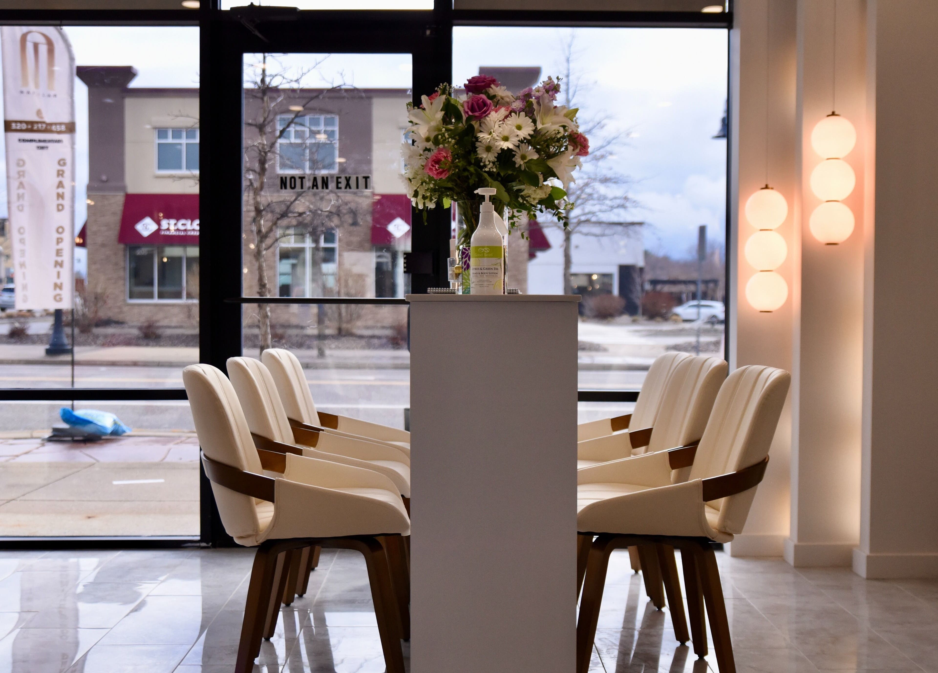 Interior view of NT Nail Lab, elegant chairs and floral arrangement, Sauk Rapids, Minnesota, US.