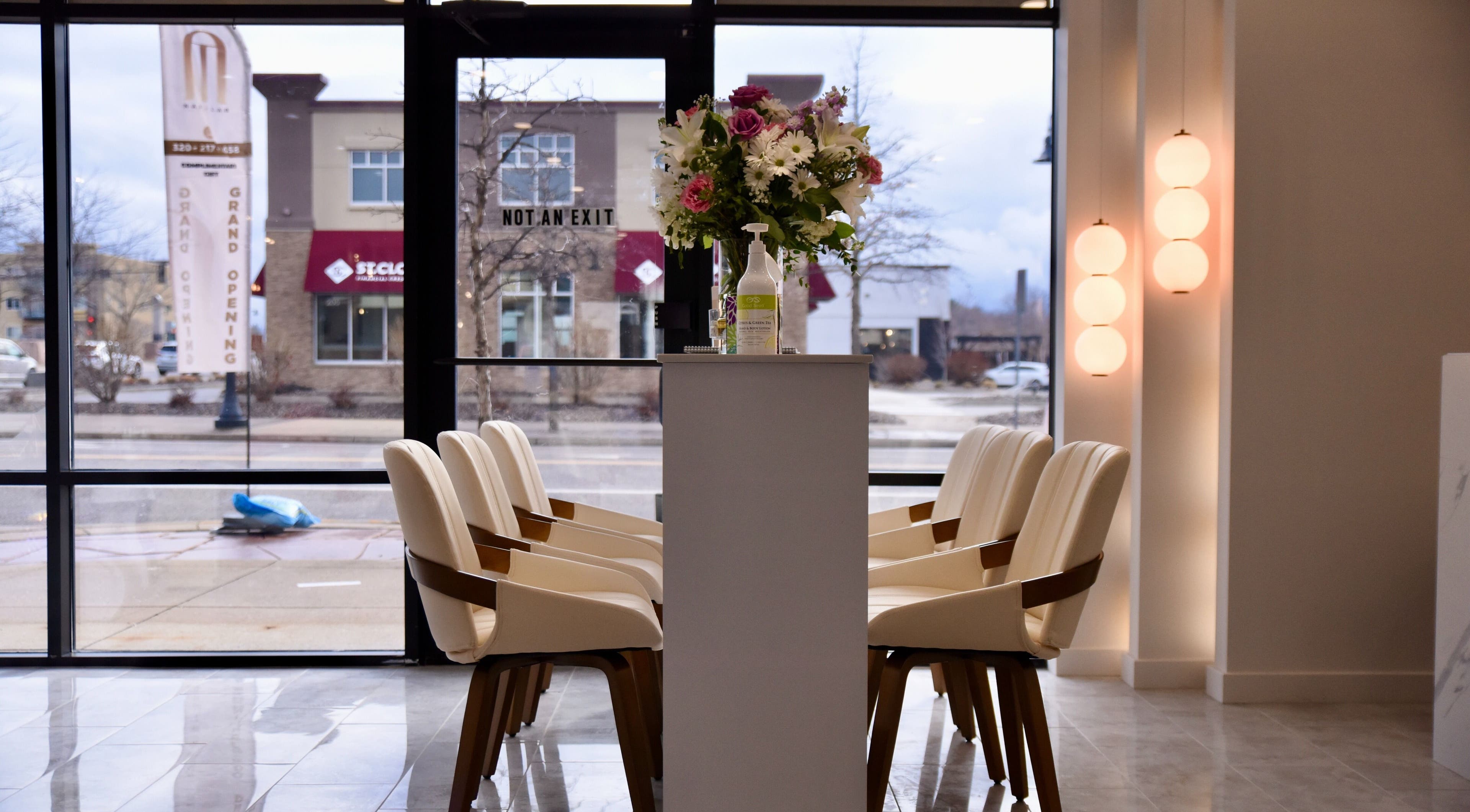 Interior view of NT Nail Lab, elegant chairs and floral arrangement, Sauk Rapids, Minnesota, US.