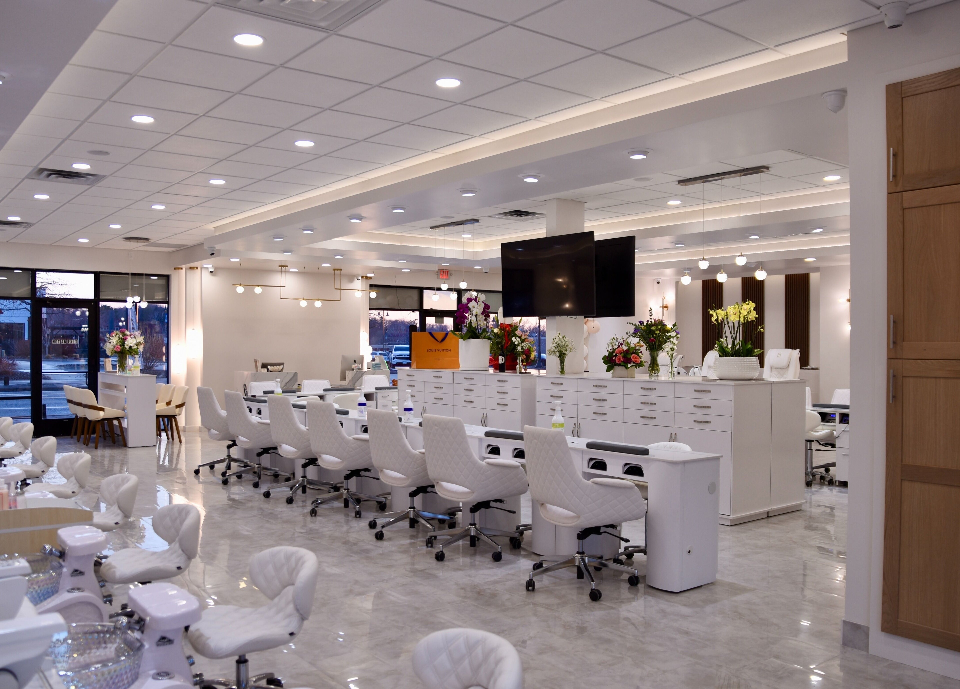Modern interior of NT Nail Lab in Sauk Rapids, Minnesota, US featuring elegant manicure and pedicure stations.