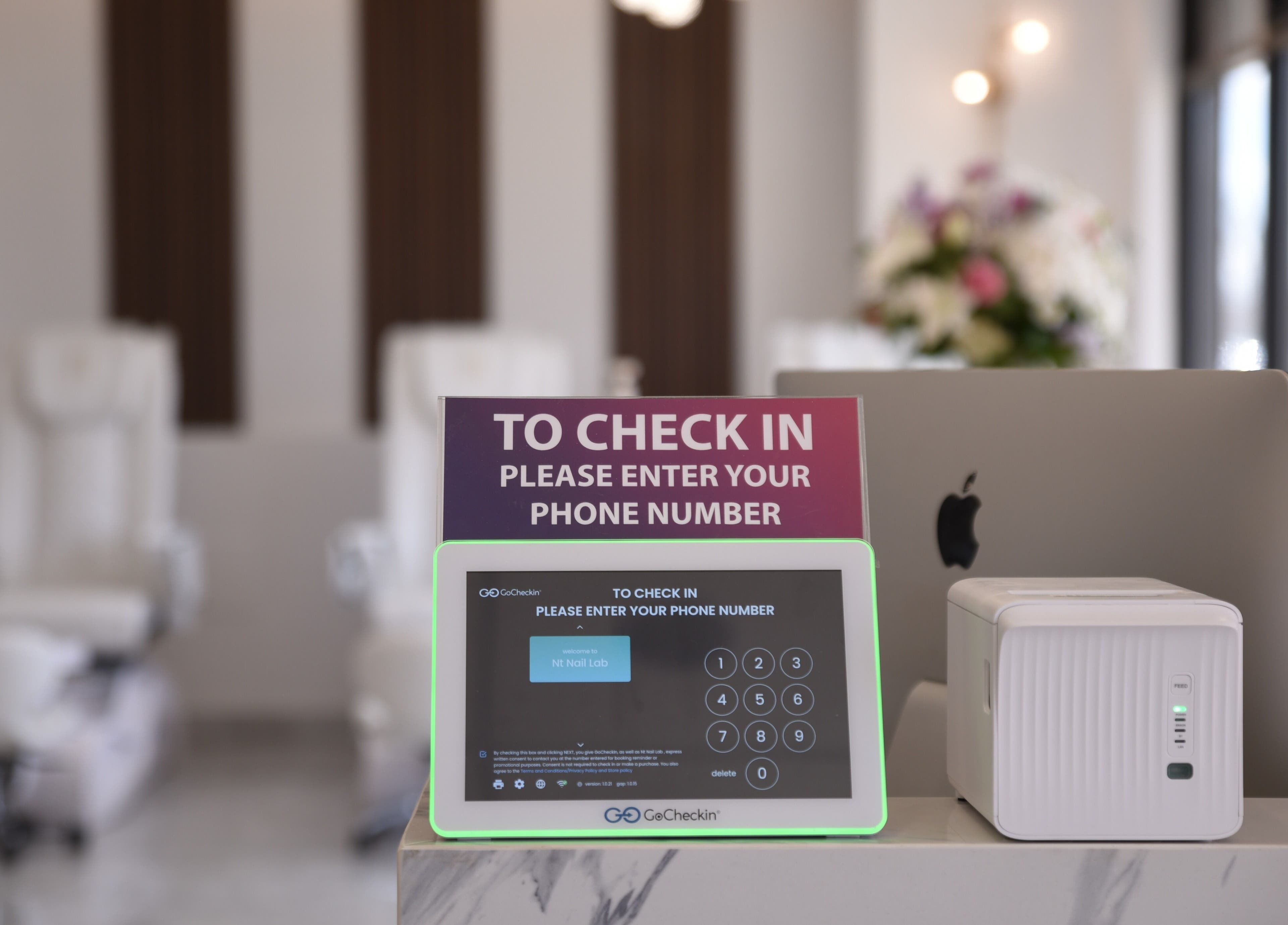 Modern check-in at NT Nail Lab, Sauk Rapids, Minnesota, US, featuring sleek tablet and decor.