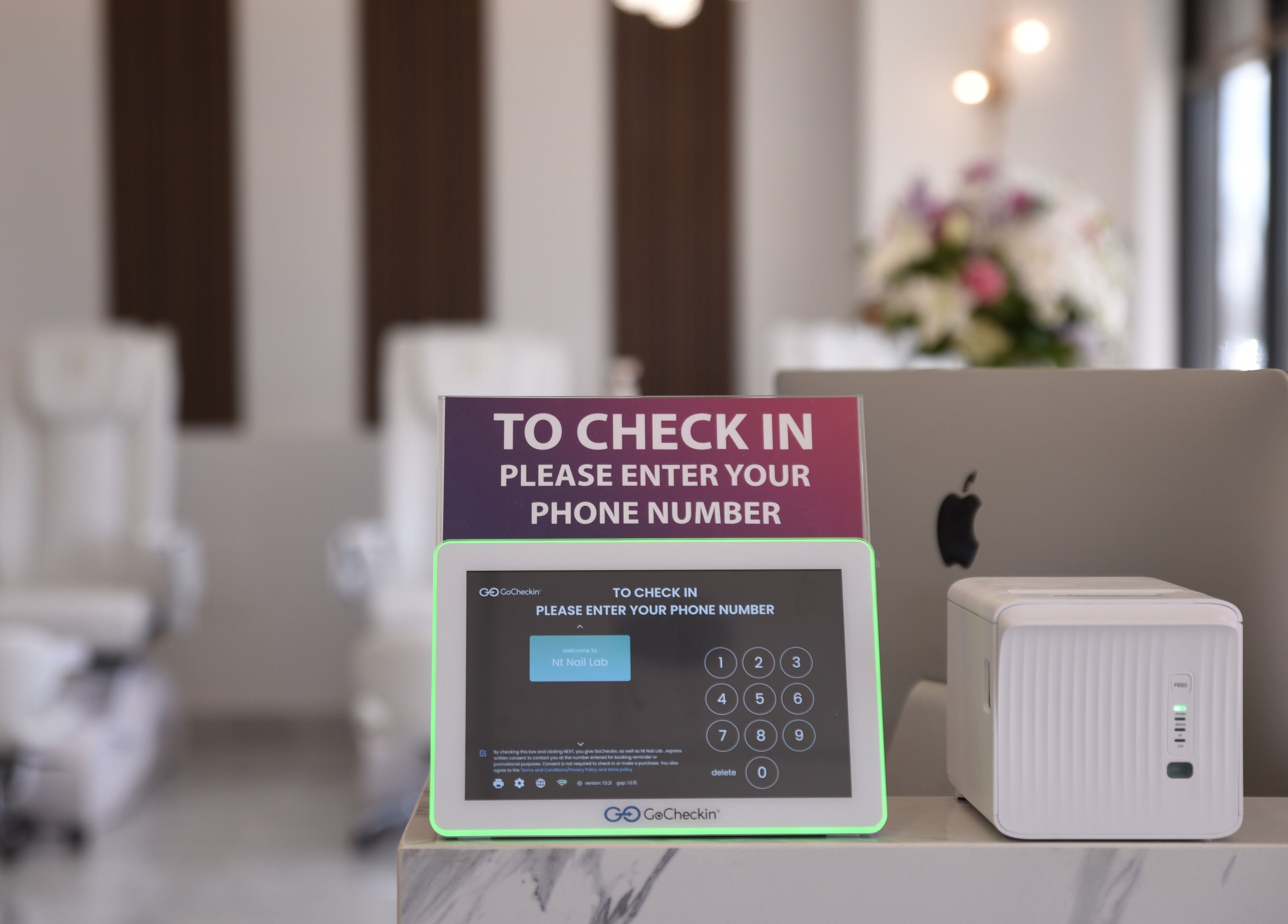 Modern check-in at NT Nail Lab, Sauk Rapids, Minnesota, US, featuring sleek tablet and decor.