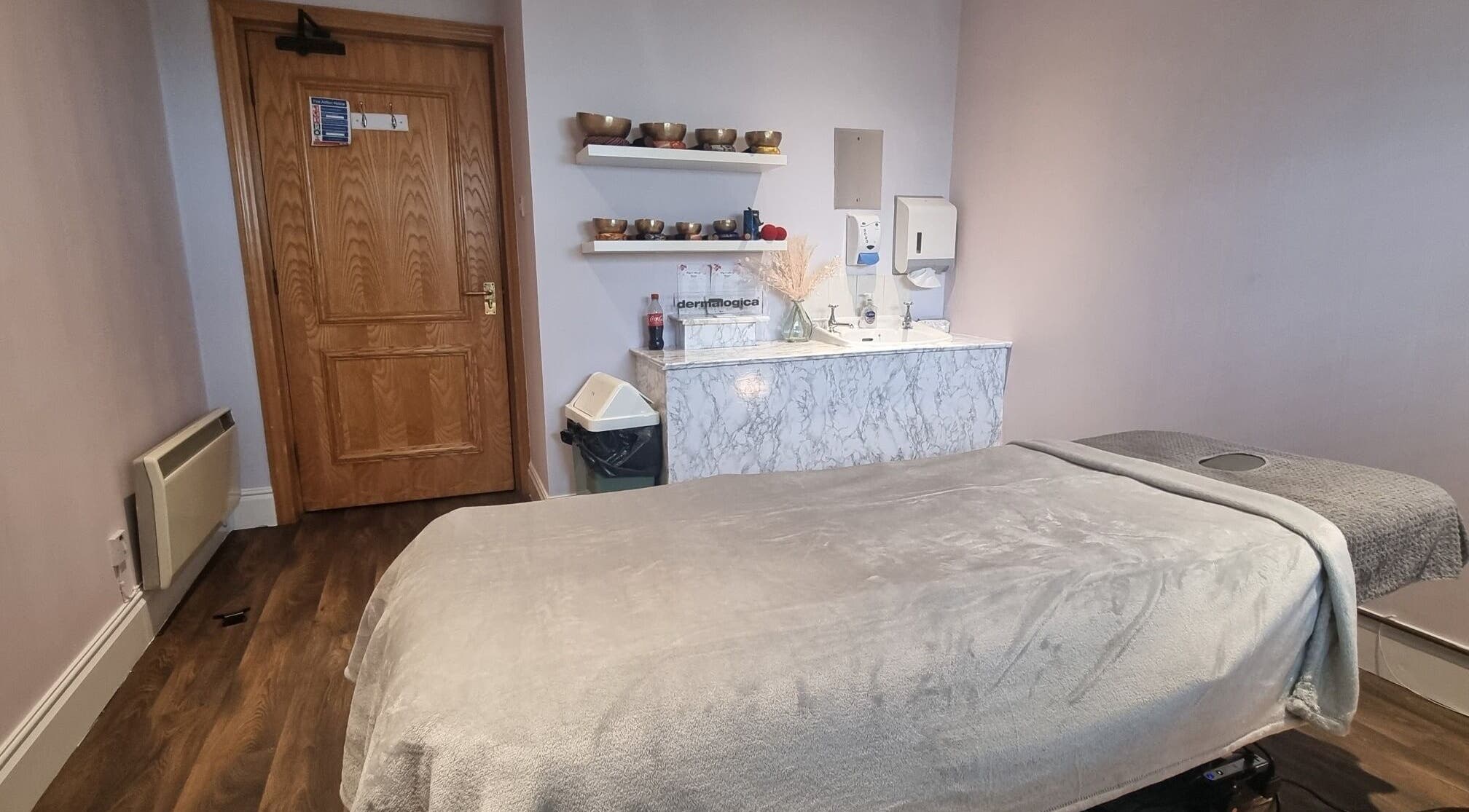 Tranquil massage room at Body & Mind by Hannah, Douglas, Douglas, IM with cozy massage bed and wooden decor.