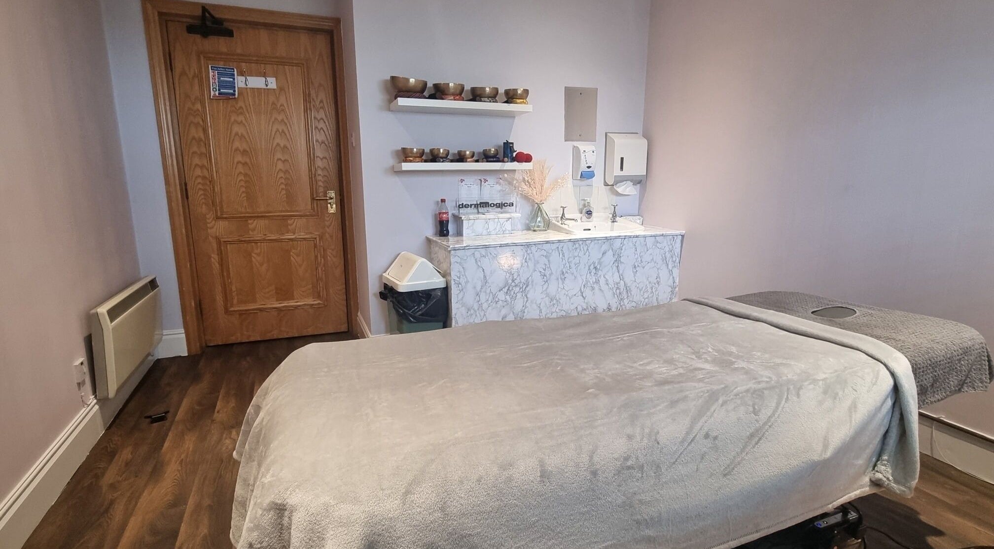 Tranquil massage room at Body & Mind by Hannah, Douglas, Douglas, IM with cozy massage bed and wooden decor.