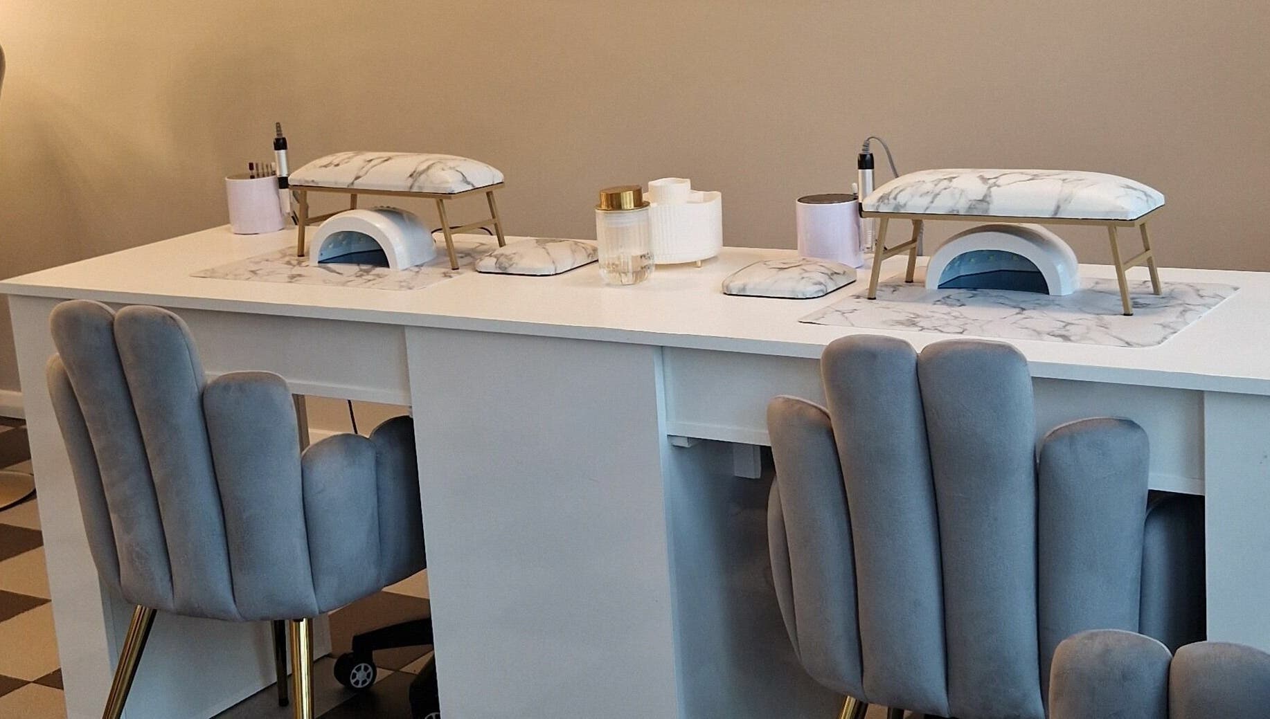 Elegant nail station at Radiant Beauty Glasson, Athlone, County Westmeath, IE with plush chairs and marble accents.