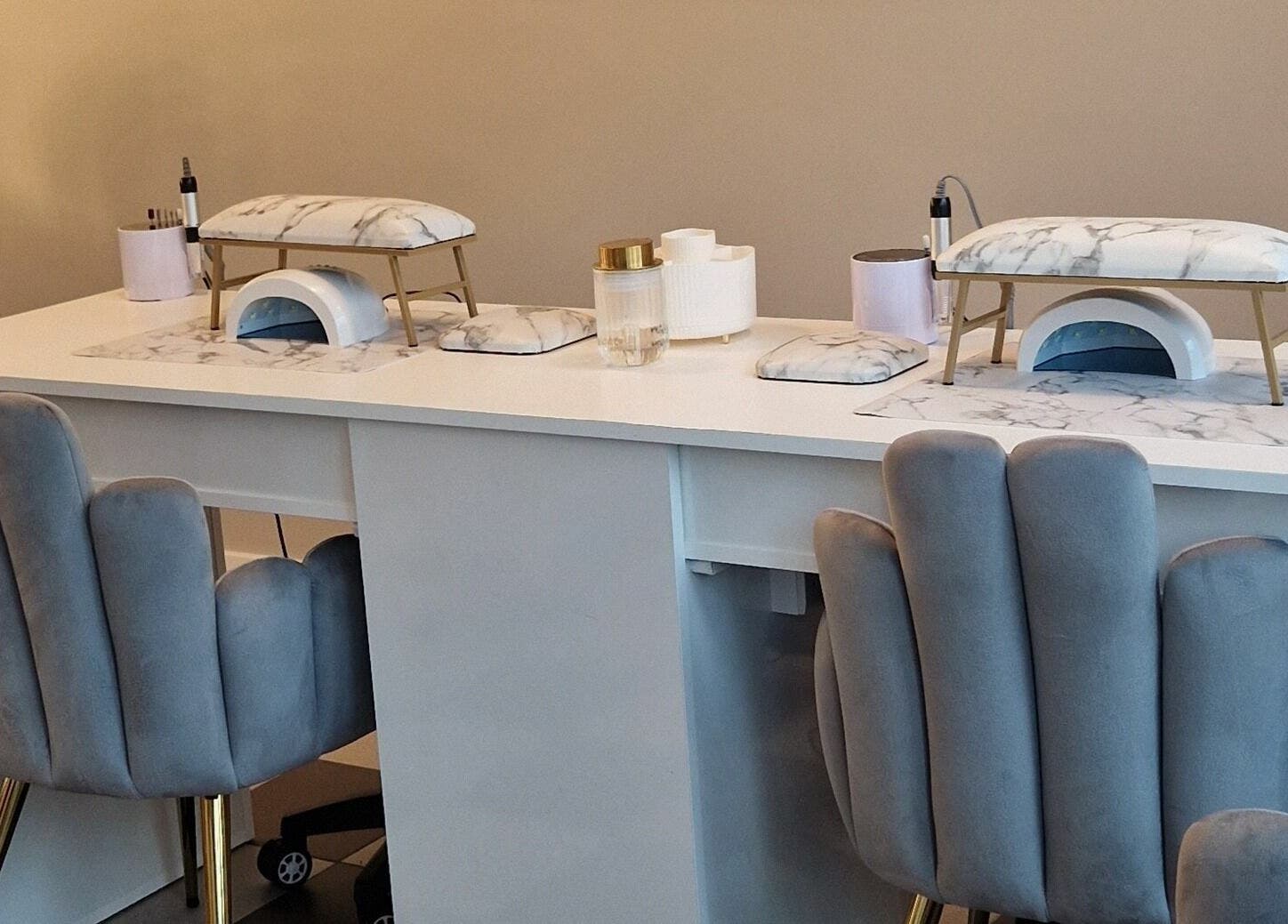 Elegant nail station at Radiant Beauty Glasson, Athlone, County Westmeath, IE with plush chairs and marble accents.