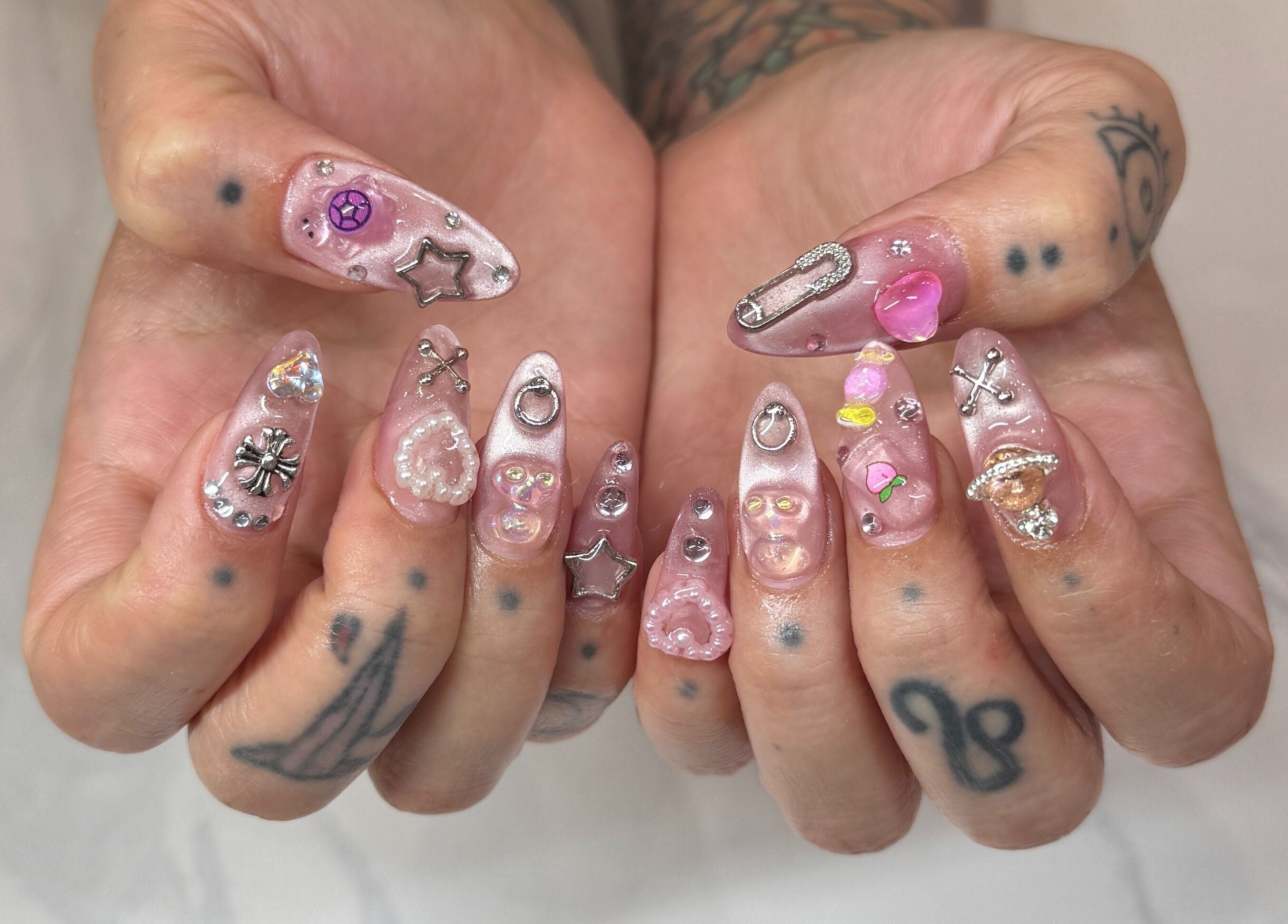 Intricate nail art with charms at Bicolor Los Feliz, Los Angeles, California, US.
