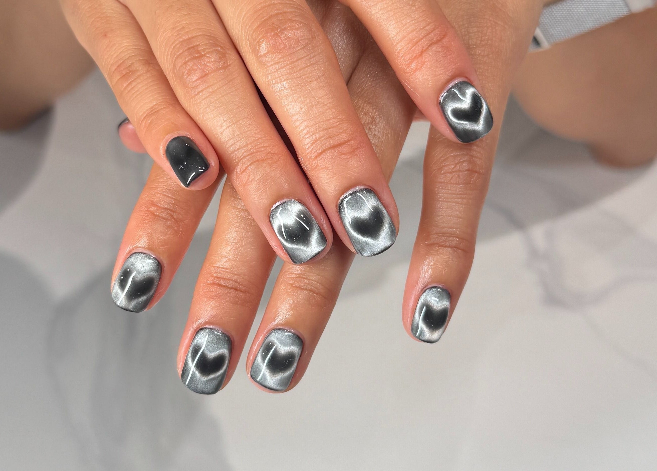 Glossy silver nails design at Bicolor Los Feliz, Los Angeles, California, US.