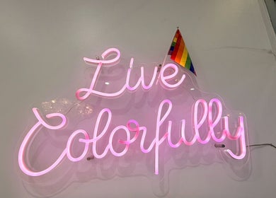 Neon sign reading 'Live Colorfully' at Bicolor Beverly Hills, Beverly Hills, California, US.