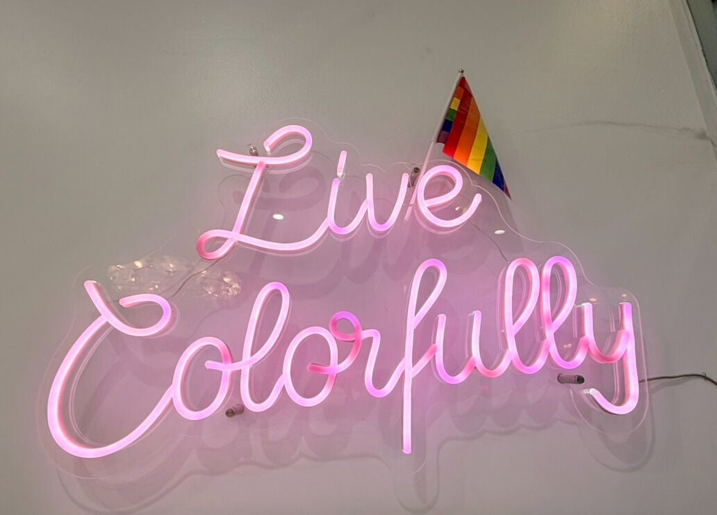 Neon sign reading 'Live Colorfully' at Bicolor Beverly Hills, Beverly Hills, California, US.